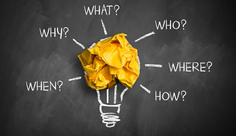 crumpled paper on a blackboard with the words "when, why, what,